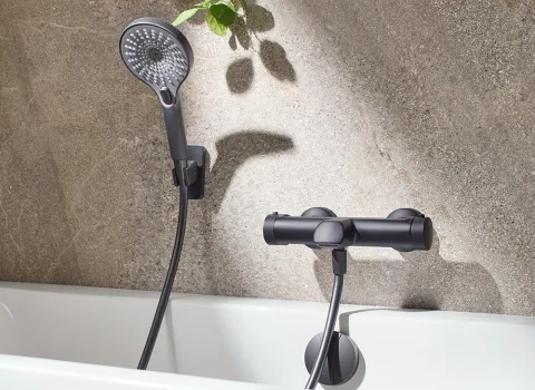 AquaXPro Badewannenthermostat in Gunmetal mit Handbrause an einer modernen Badewanne.